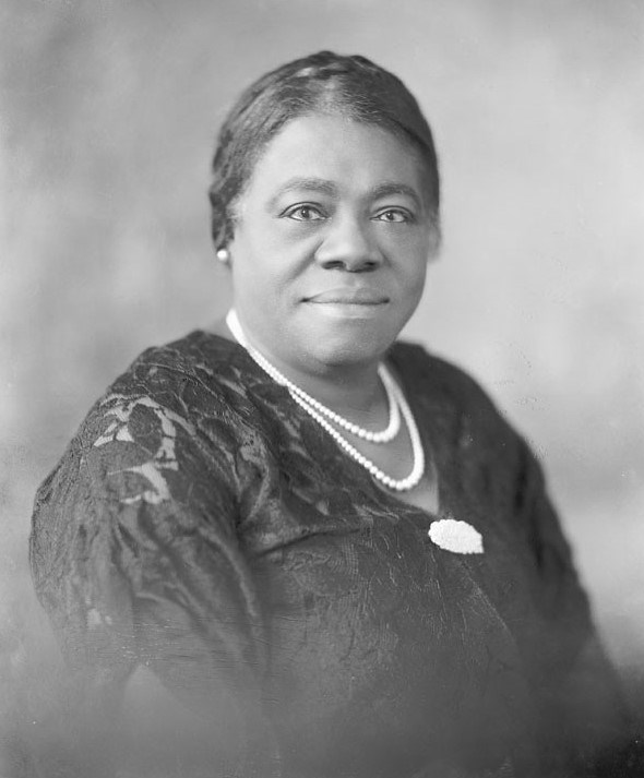 Black-and-white headshot of Mary McLeod Bethune wearing a black lace shirt and pearl necklace