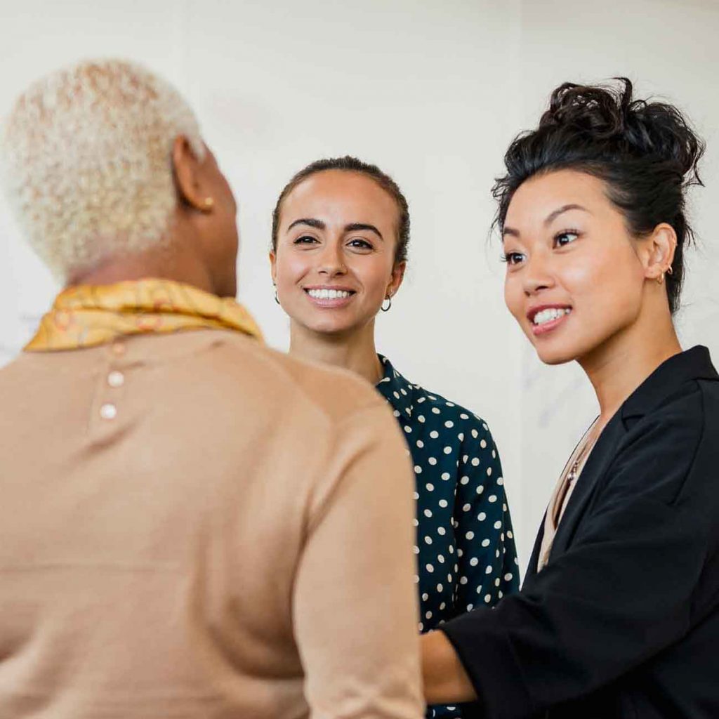 Three women talking at work