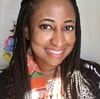 Headshot of Tina smiling with long braids and a patterned scarf