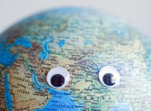 Zoomed in image of a globe with two googly eyes