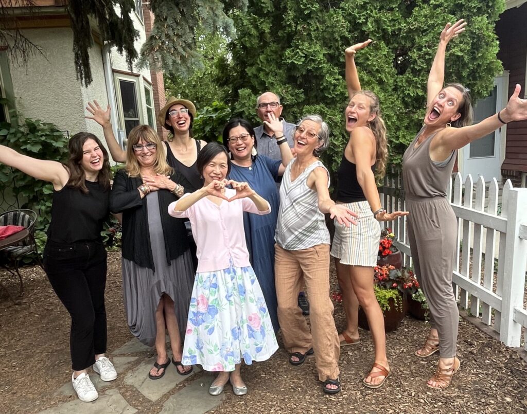 Some AmazeWorks founding community members and current staff smiling and posing cheerfully
