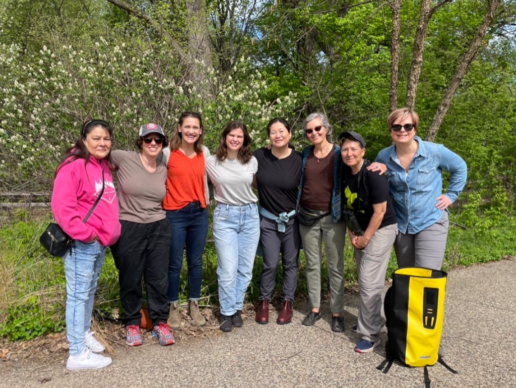 AmazeWorks staff and founding community members standing in a row and smiling after their birdwatching trip