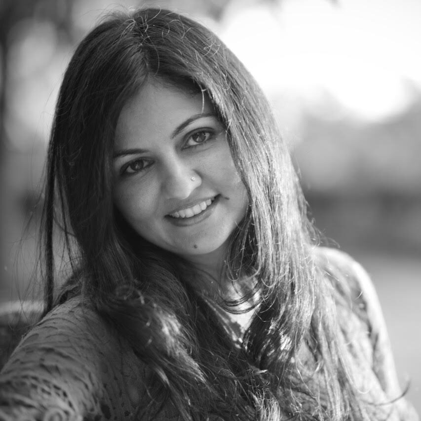 Black and white headshot of Priya Narula smiling