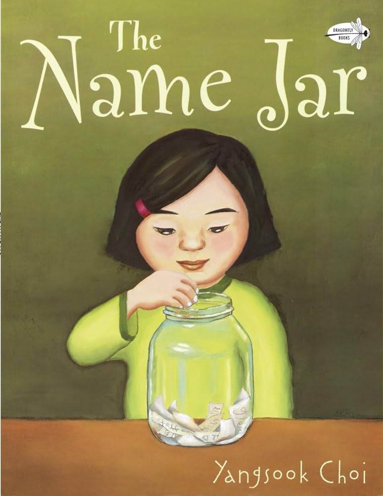 A young Asian child with short black hair wearing a red barrette. She places a slip of white paper in a mason jar full of other white slips of paper. 