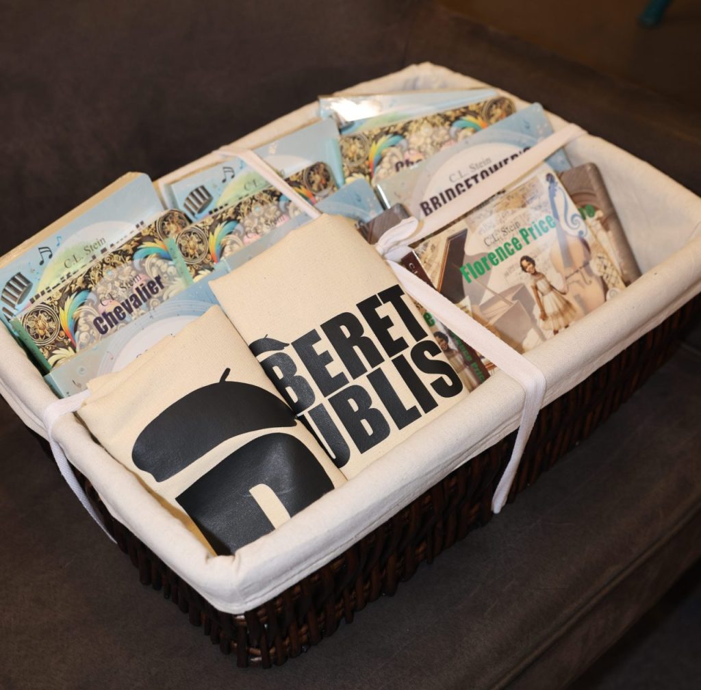 A basket filled with board books and Beret Publishing tote bags