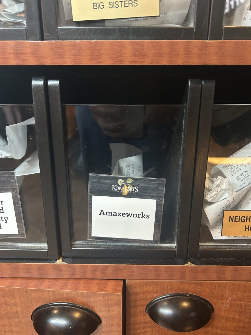 clear plastic bin labeled AmazeWorks