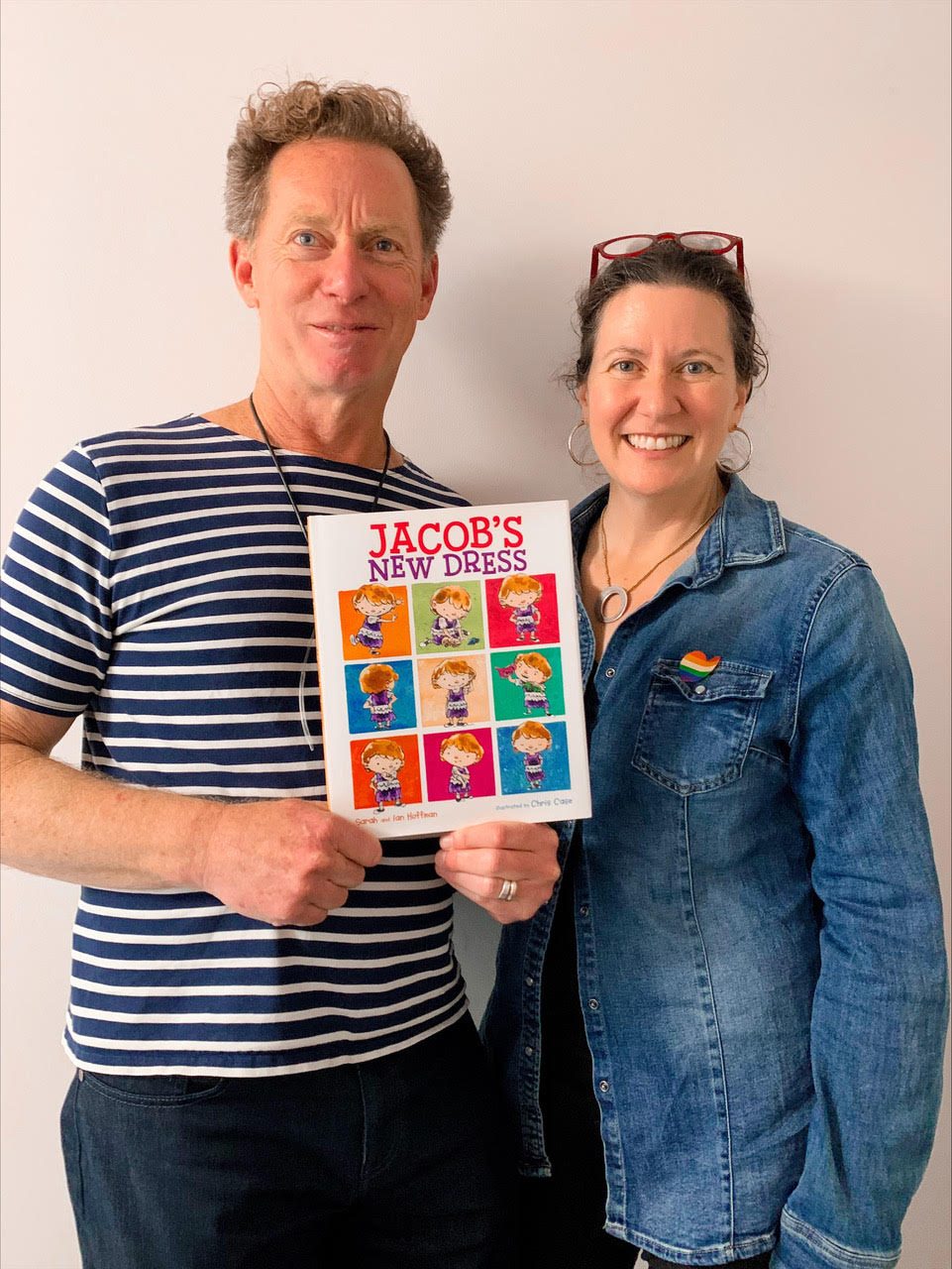 Ian and Sarah Hoffman smile while holding a copy of "Jacob's New Dress"