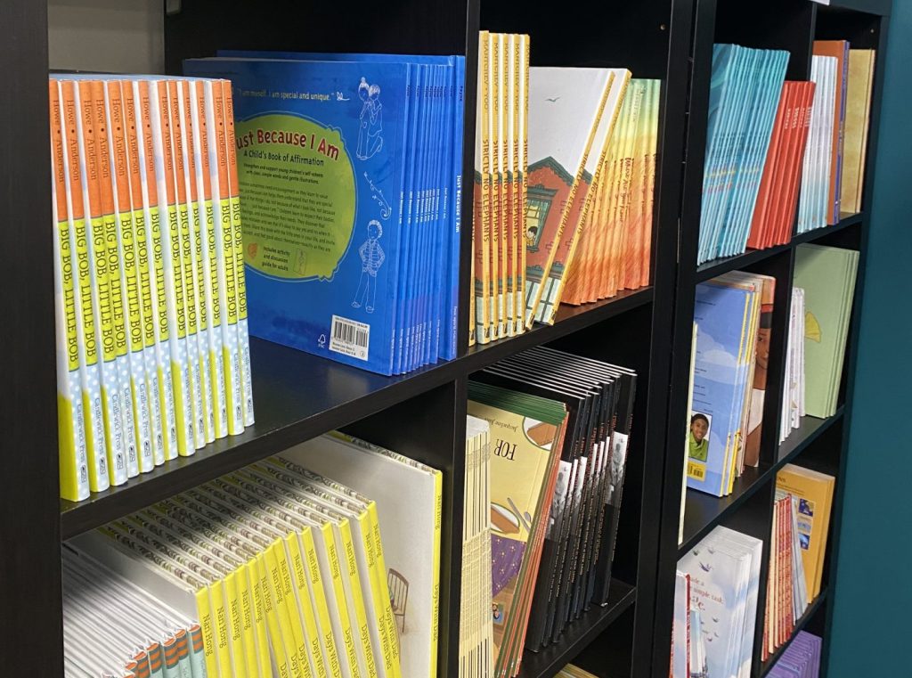 AmazeWorks book shelf, filled with colorful book spines organized by grade level
