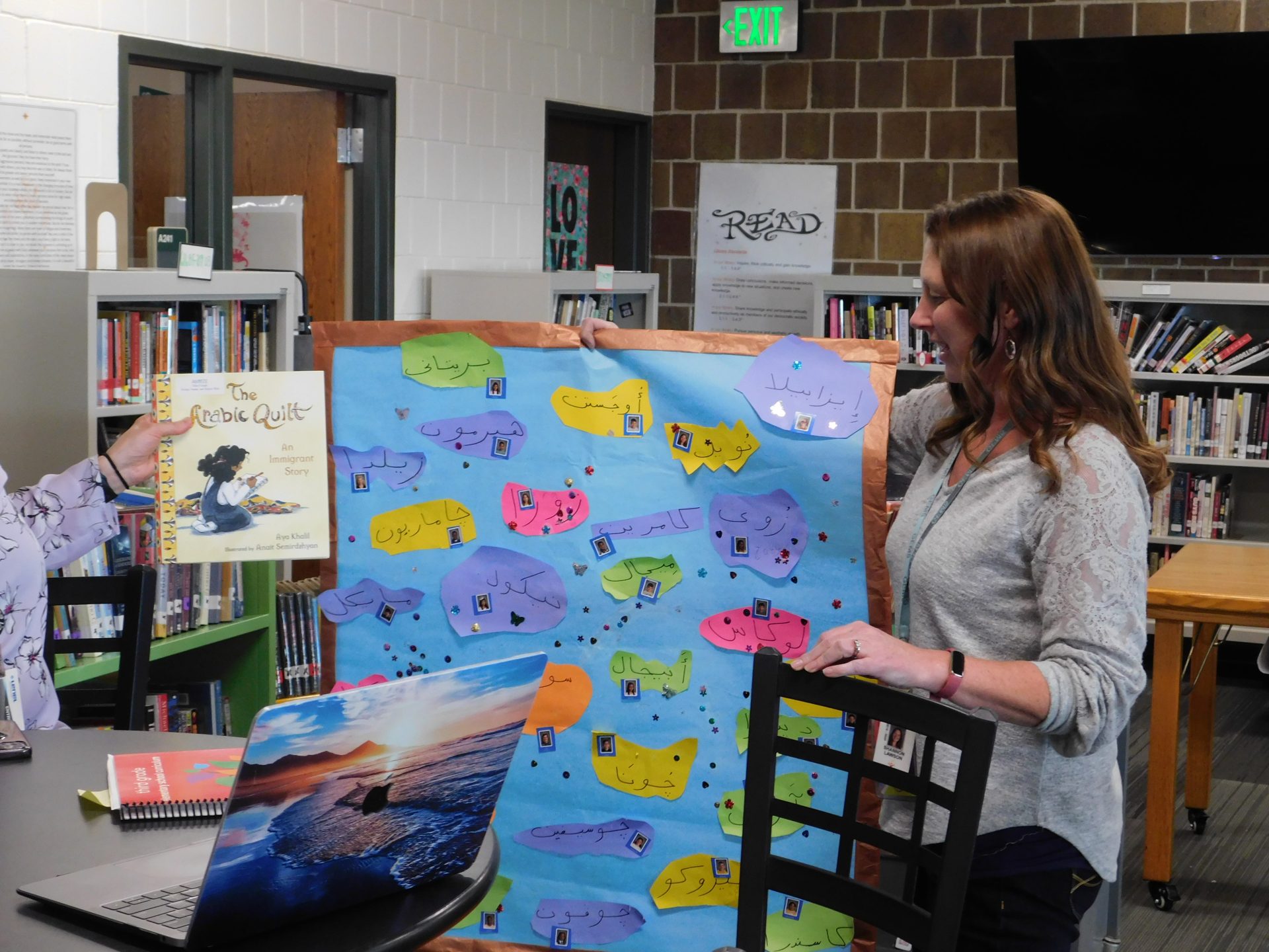 A teacher holds a class project: a recreation of the arabic quilt
