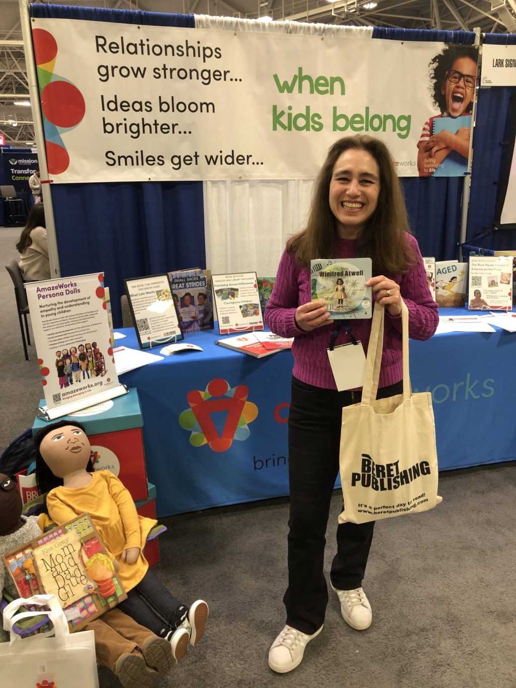 Smiling teacher posing with books