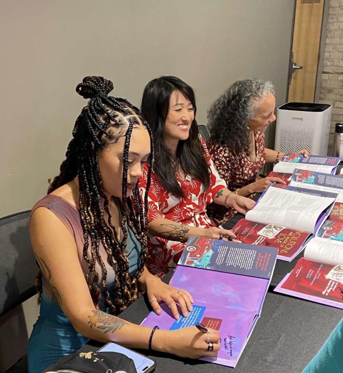 Leslie Barlow, Sun Yung Shin, and Mélina Mangal sign copies of Revolutions Are Made of Love